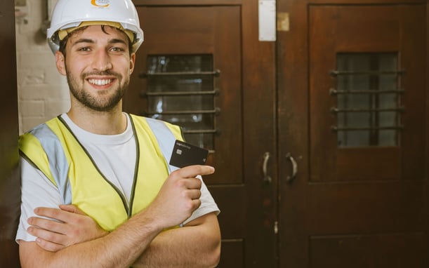 Builder holding his Capital on Tap Employee Card