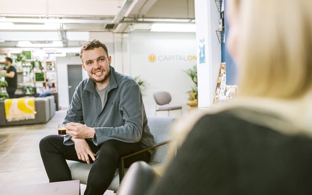 Man Sitting At Capital On Tap Office