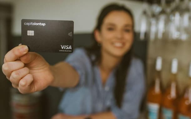 Woman In Wine Shop Holding Capital On Tap Business Credit Card Min