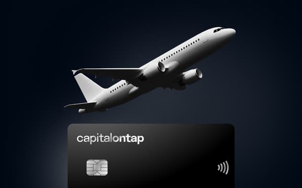Black Capital On Tap Business Credit Card With A Plane Flying Over It