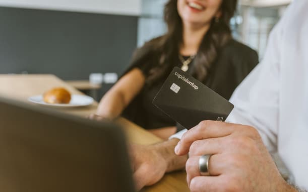 Holding Capital On Tap Business Credit Card In Front Of Laptop