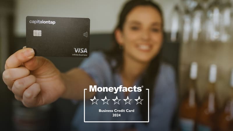 Woman In Wine Shop Holding Capital On Tap Business Credit Card
