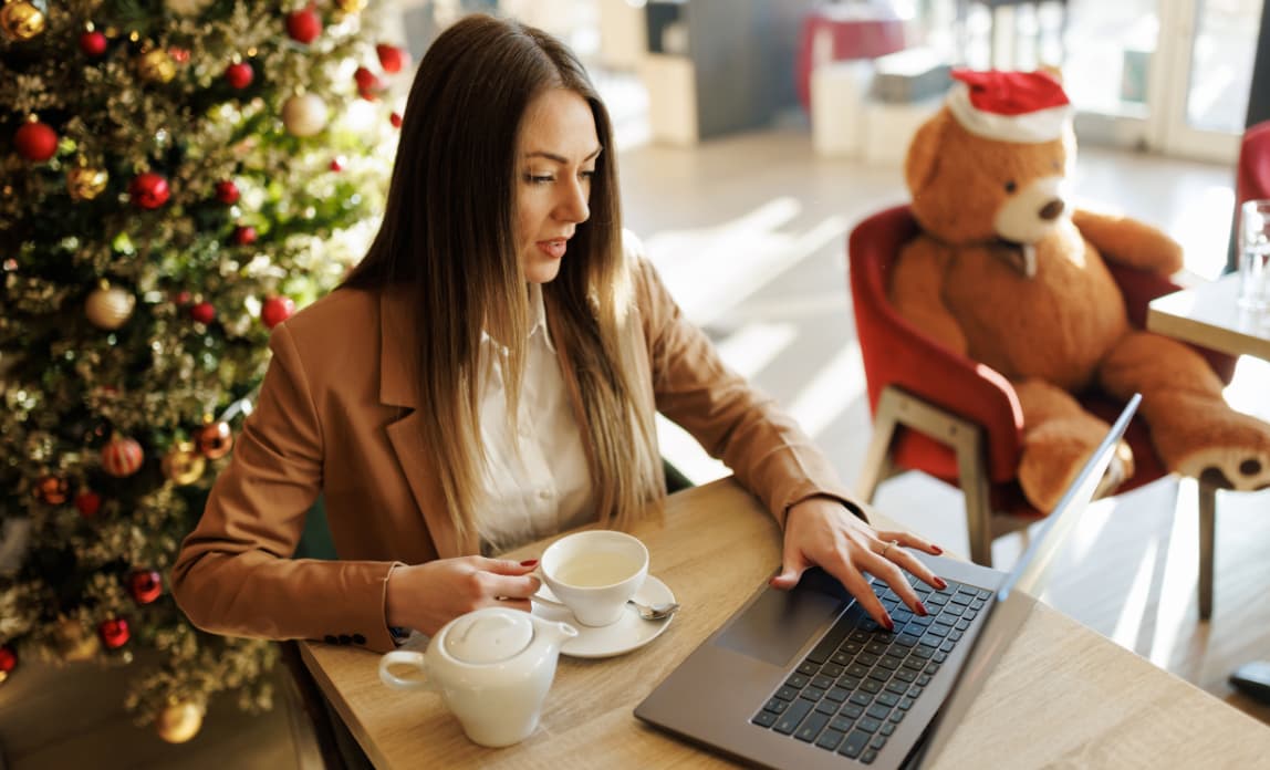 Young Woman Using Laptop At Christmas