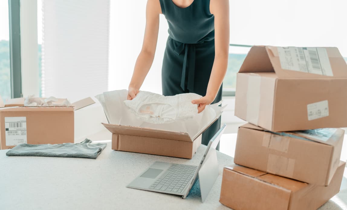Entrepreneur Woman Unpacking Items From Box