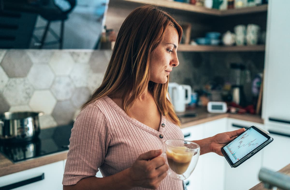 Business Owner Looking At Ipad With Coffee