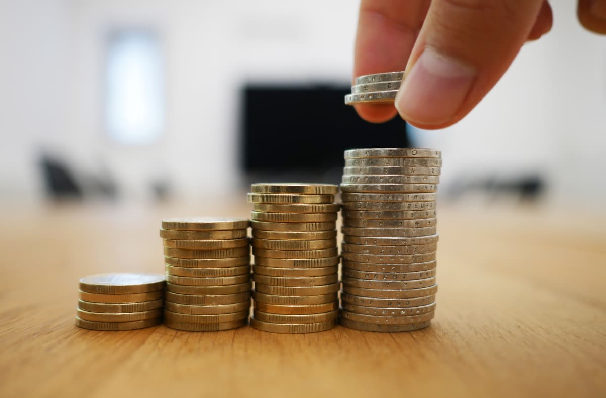 Person Stacking Coins Up