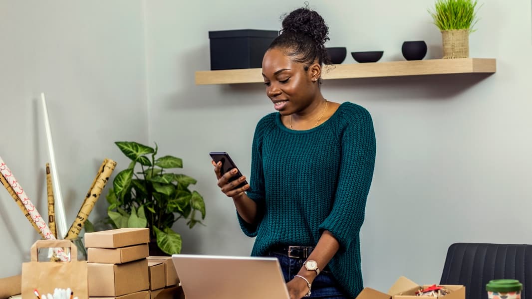 Small Business Owner Using Her Phone To Create A Tiktok