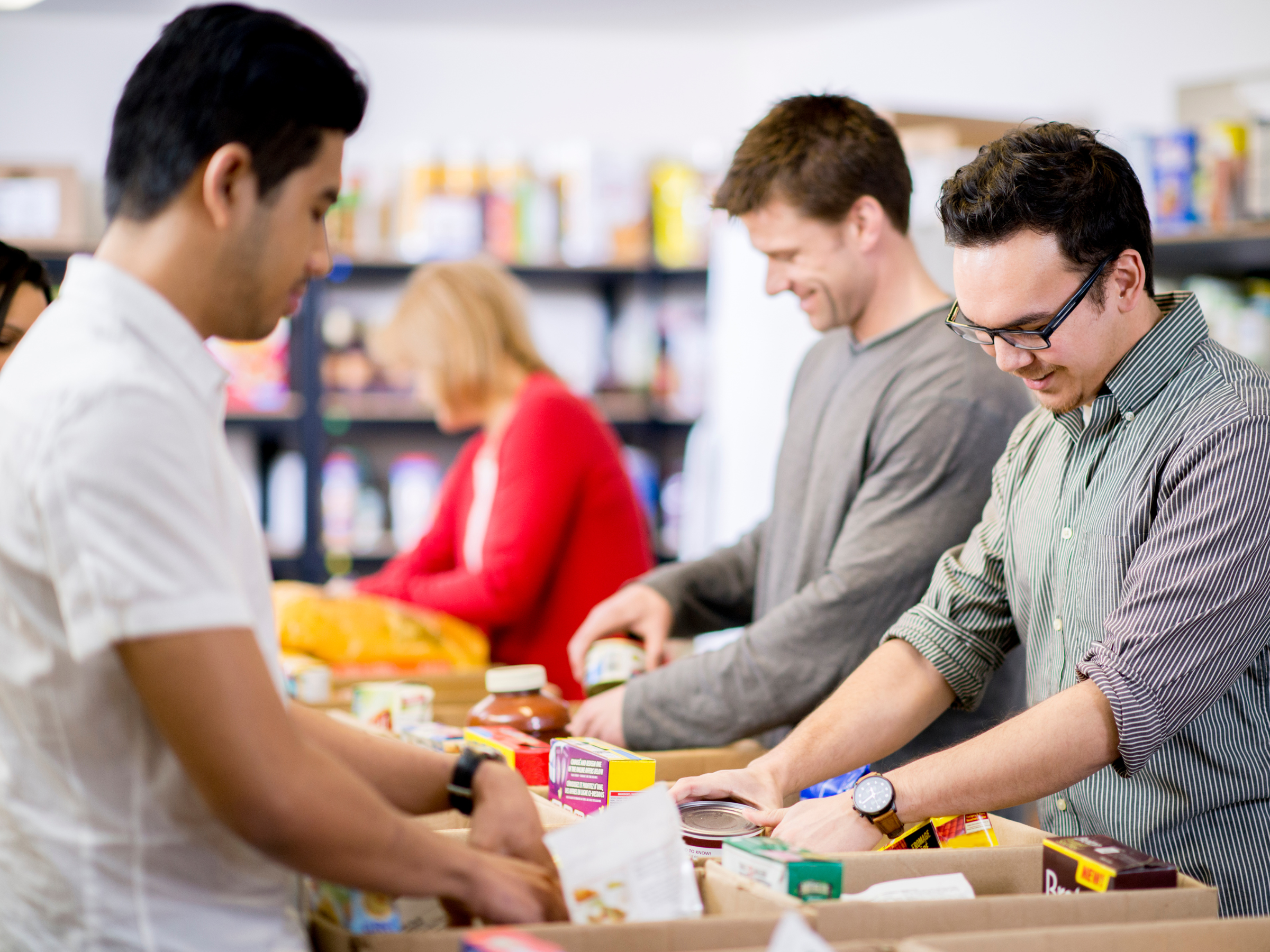 Young Adults At A Community Service Food Bank, Helping With Donations