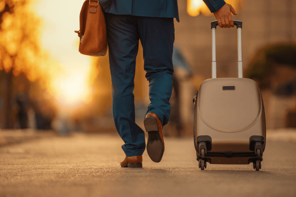 Business Traveller Pulling Suitcase Around Airport