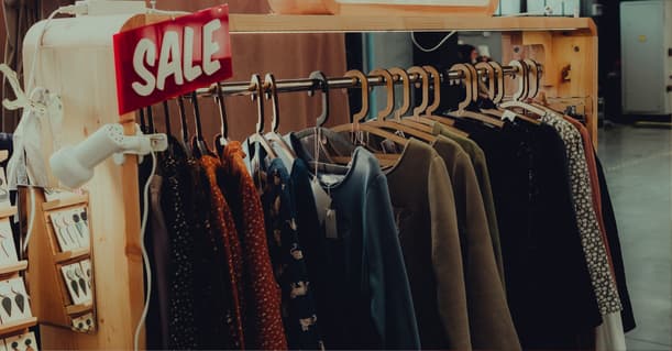 Clothing Rack With A Red Sale Sign