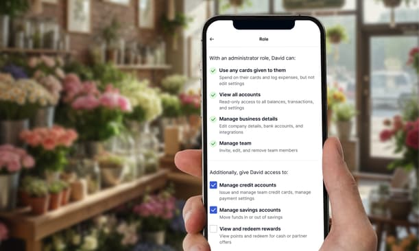 A Hand Holding A Phone Showing The Enhanced Team Management Feature On The Capital On Tap App