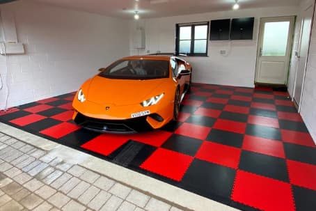 Orange Car In A Red And Black Garage