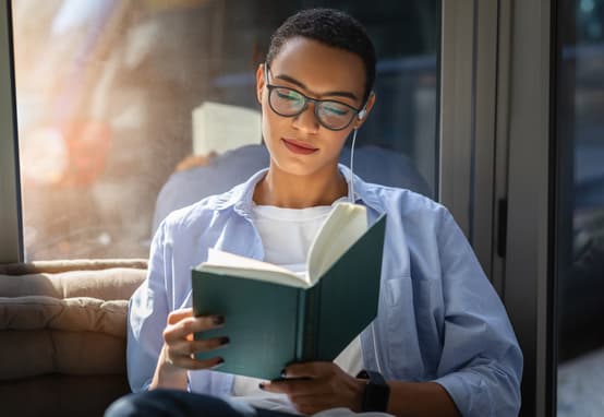 A Young Woman Using Nurosym While Reading A Book