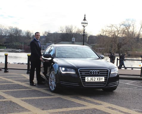 Ervin Standing Next To A Black Audi In 2013, When He First Started EG Chauffeurs