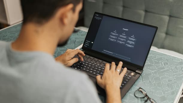 Person Typing On A Laptop With The Chatgpt Interface Open On Screen
