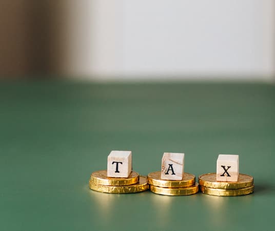 Tax Word On Top Of Gold Coins