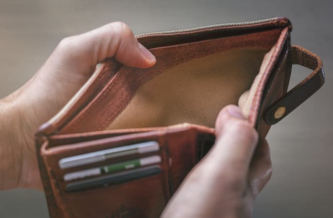 Man Holding Empty Wallet Open