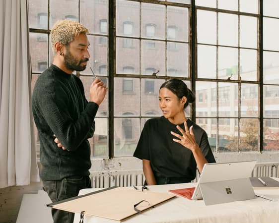 Two Colleagues Talking To Each Other In An Office Space