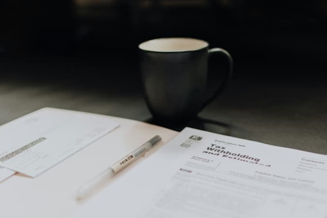 A Mug Near A Pile Of Paperwork