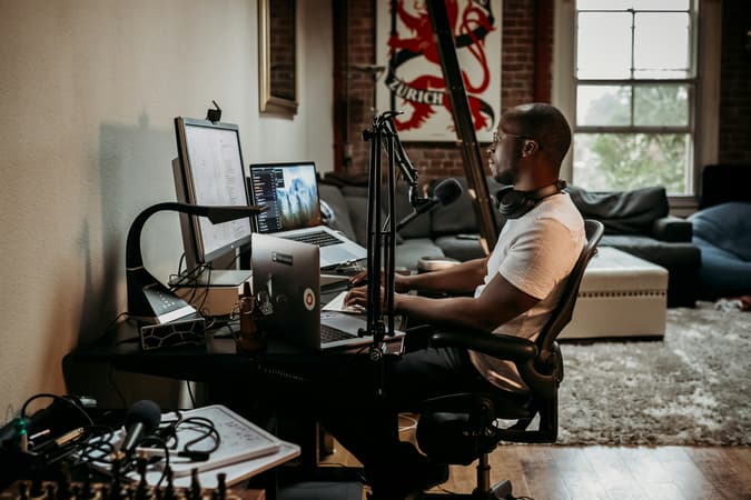 A Man With A Microphone Recording A Podcast From Home