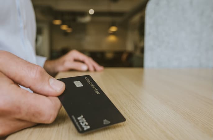 Capital On Card Being Held To Camera