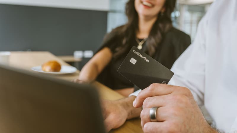 Holding Capital On Tap Business Credit Card In Front Of Laptop