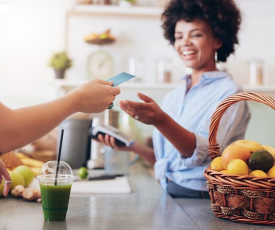 Juice Bar Owner Taking Payment From Customer