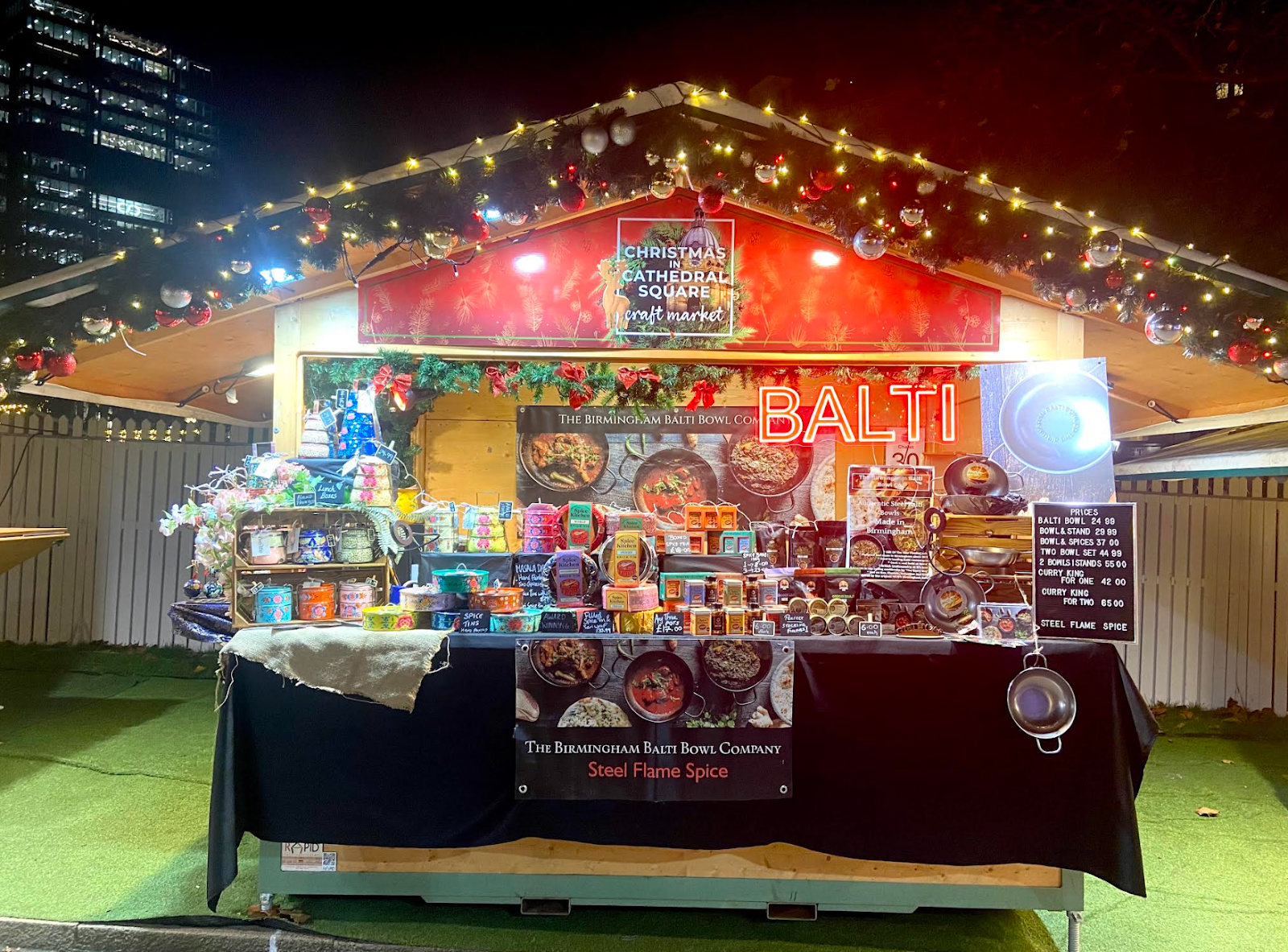 The Birmingham Balti Bowl Co Christmas Market stall, in the night time, with all the lights on