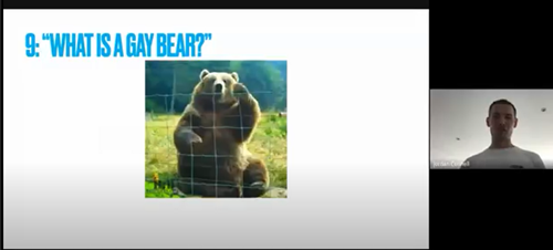 A screenshot of a zoomcall. A presentation is being shred. The slide is titled 'what is a gay bear?' there is a picture of a bear below
